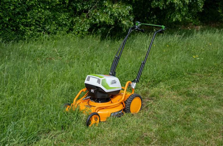 AS-Motor AS 510 E-ProClip A AP in action mowing grass, young man walking behind the mower